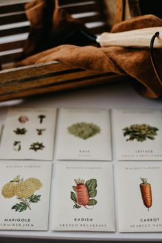 several different types of carrots are on the table next to a wooden crate and cloth