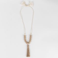 The Aaloka Beaded Tassel Necklace is your new go-to accessory! Handcrafted in India, this chunky, beaded necklace features jute beads and a tassel. Its natural finish is perfect for any season. Jute is a sustainable material made from the cellulose fibers of jute plants, a fast-growing, high-yield crop that requires little water. It’s durable, biodegradable and locally available. The adjustable knot closure lets the wearer choose between different lengths and styles. Adjustable Beige Beaded Necklace With Wooden Beads, Adjustable Beige Beaded Necklaces With Wooden Beads, Adjustable Beige Wooden Beaded Necklaces, Beaded Tassel Necklace With Round Beads For Beach, Beige Wooden Beaded Necklaces For Beach, Beige Wooden Beaded Necklaces For The Beach, Beach Beaded Necklaces With Wooden Beads In Beige, Beige Wooden Beaded Necklace For The Beach, Adjustable Natural Wooden Beaded Necklaces