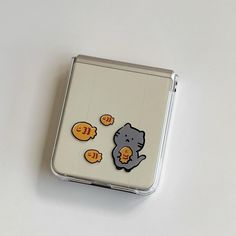 a small tin case with some stickers on it's side and an image of a cat in the middle