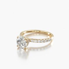 a yellow gold engagement ring with a single diamond in the center and side stones on each band