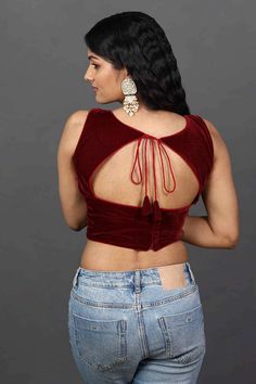 This versatile blouse pairs perfectly with any saree, creating a chic and sophisticated ensemble that is sure to turn heads. Whether you're attending a wedding, cocktail party, or any other special occasion, this Burgundy Velvet Saree Blouse is the perfect choice to elevate your look.Product Features: Color: Burgundy Fabric: Velvet Work: Solid Sleeve length: Sleeveless Closure: Back Style Fit: Regular fit Wash Care: First wash dry clean only Occasion: Festive, Casual Product Type: Blouse Disclai Blouse Designs Velvet Style, Fitted Tops For Reception During Diwali, Evening Sleeveless Bollywood Blouse Piece, Bollywood Style Sleeveless Evening Blouse, Evening Bollywood Sleeveless Blouse, Elegant Sleeveless Choli For Evening, Sleeveless Blouse Choli For Reception, Reception Top With Pallu, Elegant Evening Saree With Padded Blouse