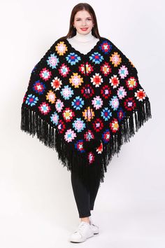 A crochet shawl for women that embodies boho charm and style, this lightweight sweater is a versatile and fashionable piece for any wardrobe. Handcrafted with intricate crochet work, it features a loose and flowy fit that drapes elegantly over the shoulders, creating a relaxed and effortless look. Perfect for layering over a simple top or dress, this boho poncho adds a touch of bohemian flair to any outfit. Whether styled with jeans for a casual day out or paired with a maxi skirt for a bohemian Black Bohemian Poncho Shawl, Black Bohemian Shawl For Fall, Bohemian Knit Poncho With Fringe, Bohemian Knitted Shawl For Beach, Bohemian Black Poncho For Fall, Bohemian Yarn Poncho One Size, Bohemian Yarn Poncho For Fall, Spring Crochet Poncho Shawl, Bohemian Yarn Crochet Top