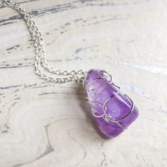 Your own custom crystal necklace, made just for you!Select from our curated collection of crystals and tumbled stones. Whether you're drawn to the calming energies of Amethyst, the vitality of Turquoise, or the grounding essence of Black Tourmaline, your choice is a reflection of your unique desires and goals. Each stone is handpicked for its natural beauty and radiates its own special energy, making this necklace not just a fashion statement but a partner on your journey. Raw Stone Crystal Pendant Necklace Gift, Gift Crystal Pendant Necklace With Raw Stone, Adjustable Amethyst Crystal Necklace As Gift, Adjustable Amethyst Crystal Necklace For Gift, Mineral Crystal Wire Wrapped Necklaces For Gifts, Sterling Silver Crystal Necklaces For Meditation, Sterling Silver Crystal Necklace With Gemstone Beads For Meditation, Tumbled Gemstone Jewelry For Healing, Handmade Amethyst Crystal Necklace For Gift