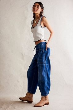 So bold in a barrel silhouette, these jeans from our We The Free collection are the definition of effortless. **Fit:** Low-slung, tapered barrel fit **Features:** Pull-on waistband for ease, drawstring detail, oversized utility pockets, soft rigid denim **Why We ❤ It:** Perfectly paired with heeled boots or off duty with ballet flats, this pair has endless ways to wear. | We The Free Silverton Puddle Barrel Jeans at Free People in Medium Wash, Size: S Barrel Jeans, Free People Summer, Drawstring Detail, 2024 Style, Utility Pockets, Earth Angel, Free People Jeans, 2024 Fashion, Wide Pants