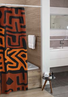 an orange and black shower curtain in a bathroom