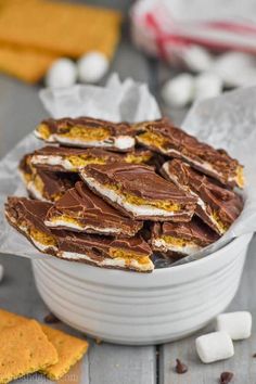 a white bowl filled with chocolate and marshmallows