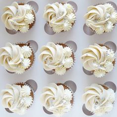 twelve cupcakes with white frosting and crystal decorations