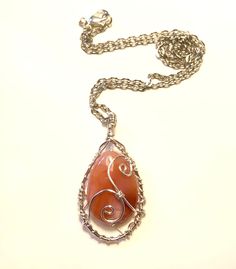 "Wire wrapped carnelian gemstone in teardrop shape,  it has swirly designs on the front.   Pendant height is about 2\", width is 1\" .  Chain is included it is about 18\". Wire is silver plate non tarnish." Swirly Designs, Chainmaille Bracelet, Carnelian Pendant, Handmade Wire Jewelry, Teardrop Beads, Handmade Wire, Copper Chain, Copper Earrings, Glass Earrings