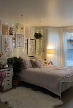 a bedroom decorated with lights and pictures on the wall