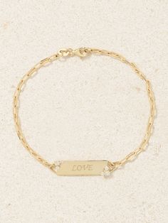 Inspired by traditional ID bracelets, STONE AND STRAND’s version is engraved with the word ‘Love’. Its handmade from 10-karat gold and punctuated with two clusters of glittering diamonds. It’s a meaningful gift for an anniversary or milestone. Dainty 14k Gold Engraved Bracelet, Dainty 14k Gold Engraved Bracelets, 14k White Gold Promise Bracelets, Dainty 14k Gold Engraved Name Bracelet, Dainty Engraved 14k Gold Name Bracelet, White Gold 14k Promise Bracelets, Dainty Engraved Yellow Gold Bracelet, White Gold 14k Promise Bracelet, Sterling Silver Gold Name Bracelet For Anniversary