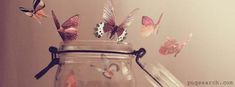 a jar filled with lots of butterflies on top of a table