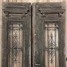 an old wooden door with wrought iron designs