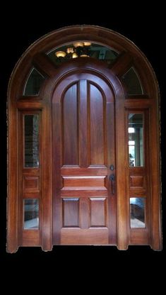 an arched wooden door with glass panels