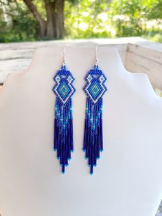 These Beautiful Native American Beaded Earrings are custom made by Elaine out of Blue, White, Turquoise and Silver with blue bugle beads on them.  They are 5 inch long and 1 inch wide with silver ear wires on them, can be changed to post or clips. If you like them and want in another color just let me know I do special orders.  Thanks for looking. Native American Beadwork Patterns, Native Crafts, Southwestern Boho, Native American Beaded Earrings, Native American Beadwork, Native American Style, Nativity Crafts, Beadwork Patterns, Native American Beading