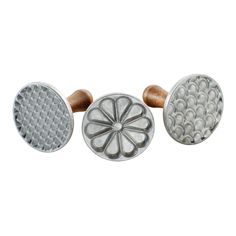 three different types of knobs on a white background and one has a flower design