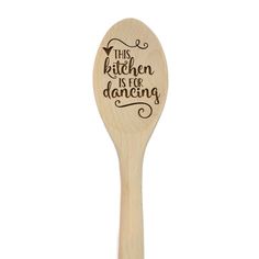 a wooden spoon with the words this kitchen is for dancing on it