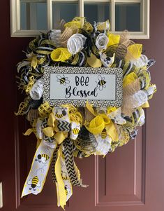 a yellow and black bee wreath with the words bee messed hanging on it's front door