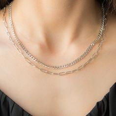 Elegant and timeless, this stainless steel silver necklace is the perfect blend of sophistication and simplicity. Crafted from high-quality stainless steel, it features a delicate chain that drapes gracefully around the neck. The necklace shines with a polished finish, offering a versatile accessory that complements both casual and formal attire. Its minimalist design makes it ideal for layering or wearing solo as a statement piece. Whether you're dressing up for an evening out or adding a touch Minimalist Double Chain Metal Charm Necklace, Minimalist Double Chain Metal Charm Necklaces, Minimalist Metal Charm Necklace With Double Chain, Modern Silver Clavicle Chain Necklace, Elegant Silver Snake Chain Charm Necklace, Modern Sterling Silver Double Chain Necklaces, Silver Cable Chain Jewelry For Layering, Modern Sterling Silver Necklaces With Double Chain, Modern Sterling Silver Double Chain Necklace