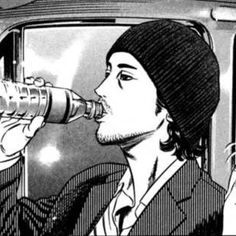 a man drinking out of a bottle while sitting in a car with another person behind him