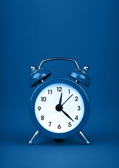 an alarm clock on a blue background