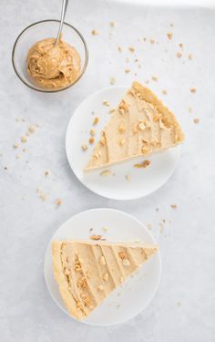 two white plates with slices of cake and peanut butter on them next to a spoon