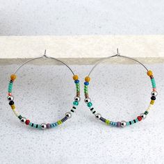 "Multicolor, beaded, boho hoop earrings.  DETAILS: ‣ Czech and Japanese glass seed beads in an array of colors ‣ shiny stainless steel beads ‣ carefully handmade, polished earring hoops, made of 316L stainless steel SIZE: ‣ hoop diameter: 1.6\" / 4 cm + beads ‣ beads: 2- 4 mm Ø Click here for more beaded hoop earrings: www.etsy.com/shop/LianuDesign?ref=seller-platform-mcnav%C2%A7ion_id%C2%A7ion_id&section_id=26956662 Or check out all items in the shop: www.etsy.com/shop/LianuDesign" Hoop Earrings With Beads, Earrings With Beads, Boho Hoop Earrings, Earring Hoops, Unique Handmade Jewelry, Beaded Hoop Earrings, Glass Seed Beads, Seed Bead Earrings, Bead Earrings