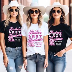 three women wearing matching shirts and hats