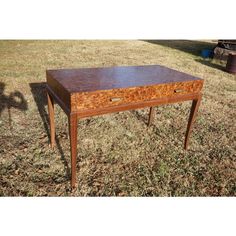 an old wooden table sitting in the grass