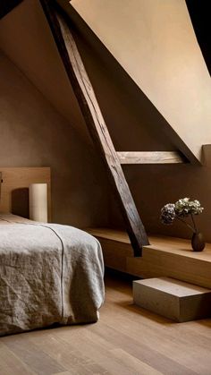 a bed sitting under a wooden beam in a bedroom next to a window with a skylight