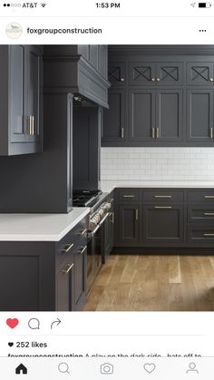 an empty kitchen with gray cabinets and white counter tops