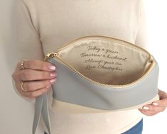 a woman is holding her personalized pouch