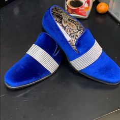 a pair of blue slippers sitting on top of a counter next to an orange