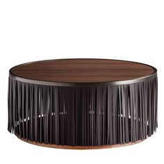 a round wooden table with fringes on it