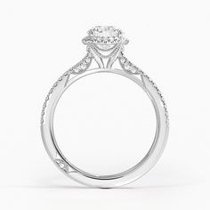 a white gold engagement ring with an oval diamond center