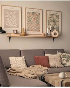 a living room filled with furniture and pictures on the wall above it's coffee table