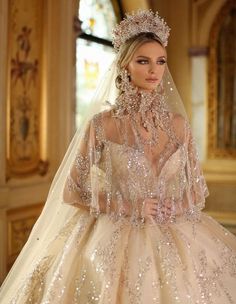 a woman in a wedding dress with a veil and tiara on her head is posing for the camera