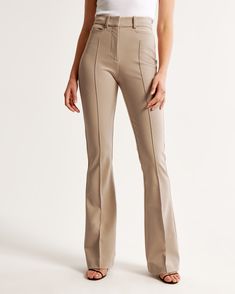 Elevate your wardrobe with the Abercrombie & Fitch Women's High Rise Flare Pant in an elegant Clay Brown. These pants are designed to flatter, fitting snugly at the waist and hips while relaxing slightly at the thigh and flowing into a full-length flare leg. Perfect for a sophisticated look, they feature:

- Size: 32 SHORT
- Color: Clay Brown
- Material: Body - Polyester blend; Pocket Bag - Polyester
- Gender: Female
- Key Details: Stretch menswear fabric, sleek pintuck detail, functional front