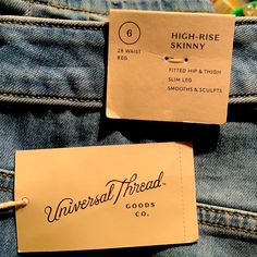 two tags on the back of some blue jeans