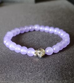 ️ Made with durable, pre-stretched crystal elastic for a perfect fit. ️ Made with lavender 6mm chalcedony stone beads with a lotus flower spacer bead in the middle.  ️ Beautiful in the light. ️ Slight color variations may occur due to flash used in photography and photo enlargement. ️ Bracelet will be shipped within 1 to 3 days except holidays. 📬 ️ If you have any questions, please don't hesitate to contact me. I will do my best to reply as soon as possible. Lavender Bracelets With Spacer Beads As Gift, Lavender Bracelets With Spacer Beads For Gift, Spiritual Lavender Beaded Bracelets As Gift, Lavender 8mm Beads Bracelet Gift, Lavender Crystal Bracelet With 8mm Beads As Gift, Lavender Beaded Crystal Bracelet As A Gift, Lavender Beaded Crystal Bracelet For Gifts, Lavender Bracelet With 8mm Beads For Meditation, Lavender Beaded Bracelets With 8mm Beads For Gift