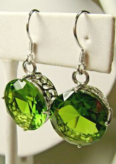 Simulated Green Peridot Earrings Round Design#E33 Made to Order This is a brand new beautiful Art Nouveau inspired filigree sterling silver pair of earrings. The gorgeous 20ctw captivating gems are high quality flawless man-made gemstones. The lovely round full cut simulated green peridots are 15mm (9/16") in diameter. The earrings are 1-5/16" long. Notice the beautiful intricate filigree designed of the settings. These are simple, elegant earrings with lovely detail.   Suggested Retail $179 **M Classic Green Earrings For Party, Green Pierced Earrings For Formal Occasions, Formal Green Pierced Earrings, Classic Green Earrings With Ear Wire, Elegant Hypoallergenic Green Jewelry, Elegant Green Hypoallergenic Jewelry, Elegant Nickel-free Green Earrings, Elegant Green Nickel-free Earrings, Formal Green Nickel-free Earrings