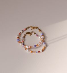 This beaded anklet is the perfect boho pop of beach colors and the pearls give it the most gorgeous shine. A must for your next vacation, you will get so many compliments. The best part is that you won't find better quality and the colors won't rub off in the ocean or pool. Grab yours today! Be sure to measure to get the best fit! White Pearl Bracelet For Summer Beach, Bohemian White Pearl Bracelet For Summer, White Bohemian Pearl Bracelet For Summer, Bohemian Beaded Bracelets For Spring Vacation, Spring Beach Beaded Necklaces With Round Beads, Handmade White Pearl Bracelet For Summer, White Handmade Pearl Bracelet For Summer, Summer Beach Pearl Bracelet, Tiny Beads Bracelets For Summer Beach