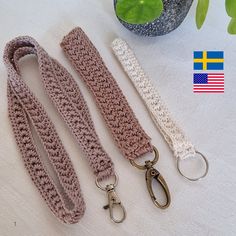 three crocheted lanyards and two key fobs on a table