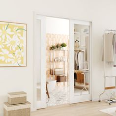 an open closet with clothes hanging on racks