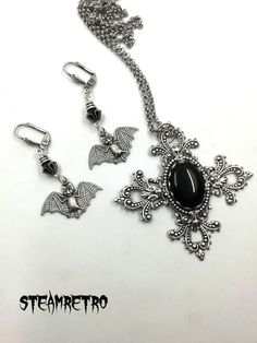 "This fantastic silver plated filigree cross necklace features a Swarovski black jet crystal and is part of our new Dark Gothic range, and is a step away from our previous steampunk work.The set comes complete with our spooky silver plated vampire bat earrings! There are numerous Gothic designers out there, and various marketplaces to purchase Gothic jewellery, but i am sure you will like what we are doing here Growing up in the 80's i lived through the \"goth\" movement, many a lost weekend was Gothic Metal Jewelry With Filigree, Gothic Filigree Metal Jewelry, Antique Silver Gothic Jewelry With Filigree, Antique Silver Gothic Filigree Jewelry, Gothic Antique Silver Filigree Jewelry, Gothic Sterling Silver Filigree Jewelry, Gothic Cross Pendant Jewelry For Halloween, Gothic Metal Cross Pendant Jewelry, Gothic Cross Pendant Jewelry