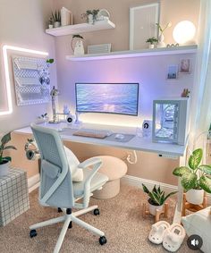 a desk with a computer on top of it in a room filled with potted plants