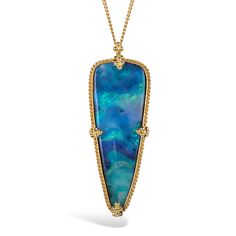 This mesmerizing Boulder Opal looks like a window into another universe, with its iridescent striations of blues and greens. We have set this show-stopping gemstone in a handmade gold pendant with braided detail, suspended from an 18K yellow gold chain. Technical Details Metal: 18k yellow goldBoulder Opal: 16.38 cts.Pendant Size (not including bail): 37.5mm x 15mmChain: can be worn at 16" and 18"Closure: lobster claspHandmade in New YorkStyle # N-3525-BOP Large Opal Necklace, Elegant Opal Jewelry With Large Pendant, Bohemian Opal Pendant Necklace, Luxury Yellow Gold Opal Necklace, Elegant Opal Necklace With Large Pendant, Luxury Opal Gemstone Necklaces, Luxury Opal Pendant Necklace, Opal Multi-stone Pendant Necklace, Mixed Metal Bracelets