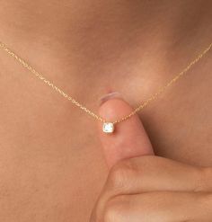 a close up of a person's stomach with a tiny diamond necklace on it