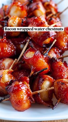 bacon wrapped in toothpicks on a white plate