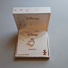 a box with a necklace in it that says disney on the front and bottom side