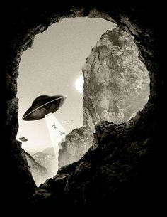 a black and white photo of a man's face through a hole in the rock